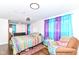 Bright bedroom with hardwood floors, a colorful bedspread, and sheer curtains at 1248 Hathaway Dr, Indianapolis, IN 46229
