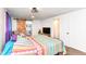 Cozy bedroom with en suite bathroom, hardwood floors, and a colorful bedspread at 1248 Hathaway Dr, Indianapolis, IN 46229