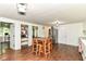 Open kitchen with stainless steel appliances, white cabinets, hardwood floors, and pantry storage space at 1248 Hathaway Dr, Indianapolis, IN 46229