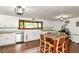 Kitchen with white cabinetry, stainless steel appliances, hardwood floors, and a dining table at 1248 Hathaway Dr, Indianapolis, IN 46229