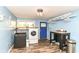 Functional laundry room with washer, dryer, storage and bright blue accents at 1248 Hathaway Dr, Indianapolis, IN 46229