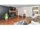Cozy living room featuring a painted brick fireplace, hardwood floors, and ample natural light at 1248 Hathaway Dr, Indianapolis, IN 46229