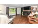 Cozy living room featuring a painted brick fireplace, hardwood floors, and ample natural light at 1248 Hathaway Dr, Indianapolis, IN 46229