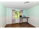 Bright office space with wainscoting, large window, and modern adjustable height desk at 1248 Hathaway Dr, Indianapolis, IN 46229