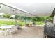 Outdoor covered patio featuring a white table, seating, and a grill at 1248 Hathaway Dr, Indianapolis, IN 46229