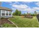 Expansive backyard with playset and verdant lawn, providing a serene outdoor space for recreation at 12672 Amber Star Dr, Noblesville, IN 46060