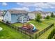 Fenced backyard with playset and ample green space, ideal for Gathering activities and relaxation at 12672 Amber Star Dr, Noblesville, IN 46060
