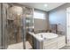 Modern bathroom featuring a walk-in shower and a luxurious soaking tub perfect for relaxation and comfort at 12672 Amber Star Dr, Noblesville, IN 46060
