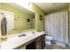 Bathroom with vanity and shower/tub with light green colored walls and grey flooring at 12672 Amber Star Dr, Noblesville, IN 46060