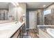 Modern bathroom featuring a walk-in shower and a luxurious soaking tub perfect for relaxation and comfort at 12672 Amber Star Dr, Noblesville, IN 46060