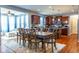 Open concept: Dining room flows into kitchen with wooden cabinets, stainless steel appliances, and island at 12672 Amber Star Dr, Noblesville, IN 46060