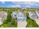 Stunning aerial view of a two story home with lush green lawn, manicured landscaping, and a three-car garage at 12672 Amber Star Dr, Noblesville, IN 46060