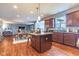 Spacious kitchen with a center island, wood cabinets and adjacent dining and living areas at 12672 Amber Star Dr, Noblesville, IN 46060
