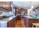Well-lit kitchen featuring wood cabinets, stainless steel appliances, a center island and laminate floor at 12672 Amber Star Dr, Noblesville, IN 46060