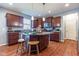 Bright kitchen features a center island with seating, stainless steel appliances, and warm wood cabinetry at 12672 Amber Star Dr, Noblesville, IN 46060