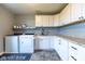Clean laundry room with modern appliances and ample cabinet space at 12672 Amber Star Dr, Noblesville, IN 46060