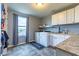 Bright laundry room with white cabinets, modern appliances, and exterior view at 12672 Amber Star Dr, Noblesville, IN 46060