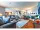 Open-concept living room with fireplace, hardwood flooring, and staircase access at 12672 Amber Star Dr, Noblesville, IN 46060