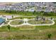 Aerial view of a neighborhood park with modern playground equipment and lush greenery at 12672 Amber Star Dr, Noblesville, IN 46060