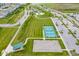 Aerial shot showcases community amenities including pickleball and basketball courts, ample parking, and green spaces at 12672 Amber Star Dr, Noblesville, IN 46060