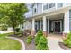 Inviting front porch with brick pillars, lush landscaping, and a well-manicured lawn leading to the front door at 12672 Amber Star Dr, Noblesville, IN 46060