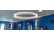 Modern chandelier with an illuminated ring design, enhancing the entertainment room's decor at 12672 Amber Star Dr, Noblesville, IN 46060