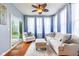 Inviting sunroom offers comfortable seating, bright natural light and calming color palette at 12672 Amber Star Dr, Noblesville, IN 46060