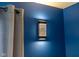 Stylish wall sconce illuminating a blue wall, complemented by a curtain at 12672 Amber Star Dr, Noblesville, IN 46060