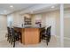 Finished basement wet bar featuring a black countertop and seating for five at 13218 Beckwith Dr, Carmel, IN 46074