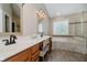 The bathroom features dual sinks, wood cabinets, and a soaking tub with tiled surround at 13218 Beckwith Dr, Carmel, IN 46074