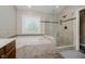 Bathroom with a soaking tub and a glass enclosed shower with tiled surround at 13218 Beckwith Dr, Carmel, IN 46074