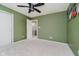 Bedroom featuring an olive green wall, ceiling fan, and access to a closet and bathroom at 13218 Beckwith Dr, Carmel, IN 46074