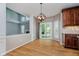 Bright dining space boasts hardwood floors, modern lighting, and access to the backyard at 13218 Beckwith Dr, Carmel, IN 46074