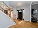 Open foyer with hardwood floors, staircase, and natural light streaming through the front door at 13218 Beckwith Dr, Carmel, IN 46074