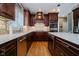 A kitchen featuring stone counters, stainless steel appliances, and wood cabinets at 13218 Beckwith Dr, Carmel, IN 46074