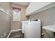 Well-organized laundry room with modern washer and dryer, storage cabinets, and functional countertop at 13218 Beckwith Dr, Carmel, IN 46074