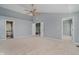 Large main bedroom with carpet, light blue walls, and views to an ensuite bathroom and stairway at 13218 Beckwith Dr, Carmel, IN 46074