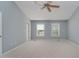 Bright main bedroom with neutral walls, carpet, a ceiling fan, and windows for natural light at 13218 Beckwith Dr, Carmel, IN 46074