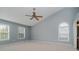 Spacious main bedroom featuring vaulted ceilings, a ceiling fan, and two large windows with natural light at 13218 Beckwith Dr, Carmel, IN 46074