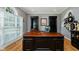 Study area featuring custom desk, hardwood floors, built-in shelving and natural light at 13218 Beckwith Dr, Carmel, IN 46074