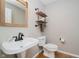 Cozy half bath with shiplap, pedestal sink and industrial shelves at 13218 Beckwith Dr, Carmel, IN 46074