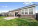 A partial view of backyard with a concrete patio, grill, and siding, near the house's sliding door entrance at 13321 N White Cloud Ct, Camby, IN 46113