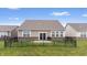 Spacious backyard with a grill, concrete patio, and black fencing to neighbor's yards on a bright day at 13321 N White Cloud Ct, Camby, IN 46113