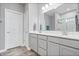 Bathroom with double sink vanity, white cabinets, and tile shower at 13321 N White Cloud Ct, Camby, IN 46113