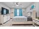 Bedroom features a ceiling fan, natural light, and neutral decor at 13321 N White Cloud Ct, Camby, IN 46113