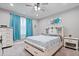 Bedroom features a ceiling fan, natural light, and neutral decor at 13321 N White Cloud Ct, Camby, IN 46113