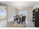 Dining room with wood table, area rug, and sliding glass doors to backyard at 13321 N White Cloud Ct, Camby, IN 46113