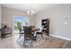 Dining room with wood table, area rug, view of the backyard at 13321 N White Cloud Ct, Camby, IN 46113
