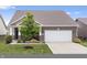 Front exterior of brick home featuring a two-car garage and well-maintained front lawn at 13321 N White Cloud Ct, Camby, IN 46113