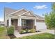 Charming brick home with a covered front porch, white pillars, and manicured landscaping at 13321 N White Cloud Ct, Camby, IN 46113